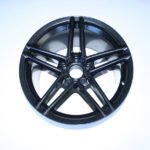 Black alloy wheel on white background.