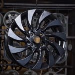 Glossy black alloy wheel on display