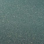 Smooth green granite surface with small specks.