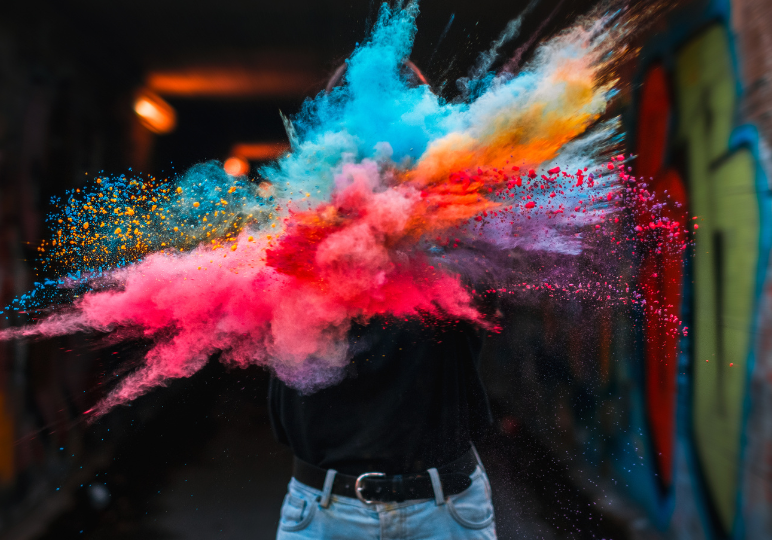 Vibrant powder burst in dark alleyway