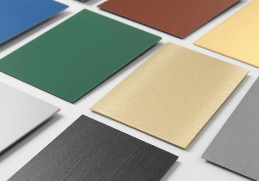 Colorful metal sheets arranged on a white surface.