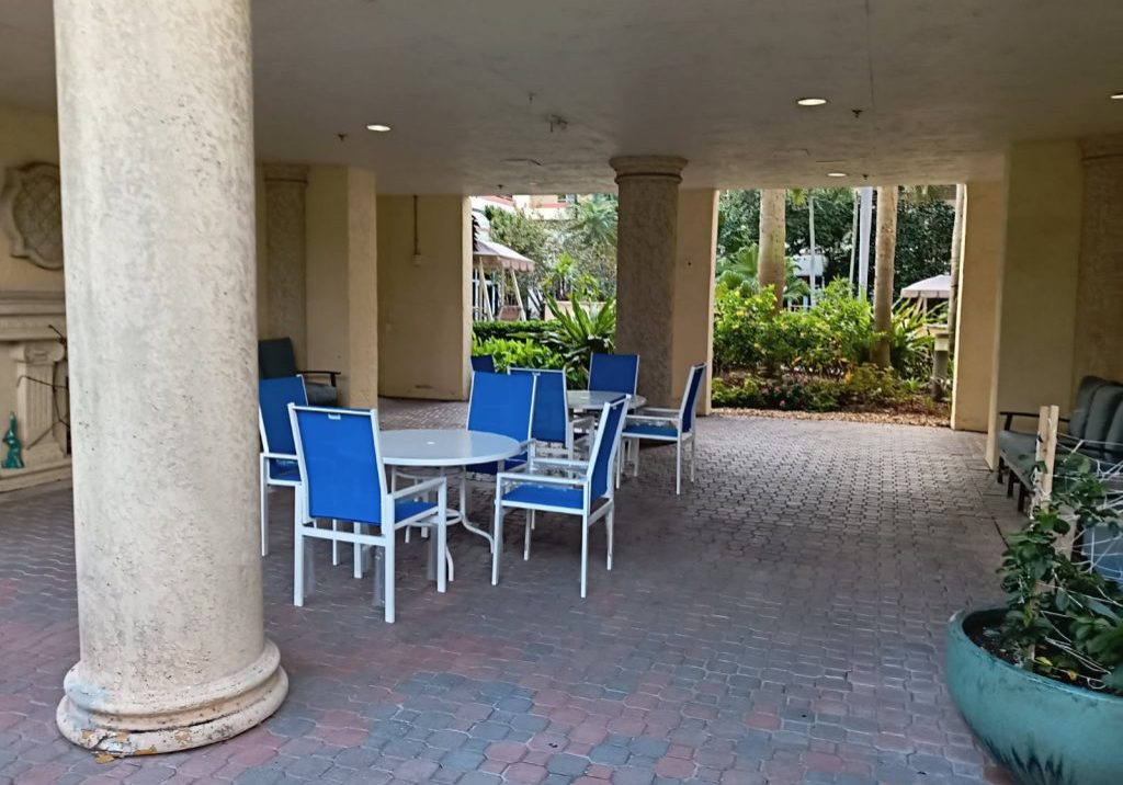 Outdoor patio with blue chairs and plants